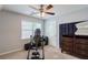 Bedroom featuring carpet flooring, a ceiling fan, dresser, and exercise machine at 8895 Club River Dr, Roswell, GA 30076