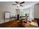 Bright bedroom featuring hardwood floors, a ceiling fan, and a large desk next to windows at 8895 Club River Dr, Roswell, GA 30076
