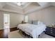 Spacious bedroom with hardwood floors, tray ceiling and large windows at 8895 Club River Dr, Roswell, GA 30076