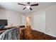 Bedroom boasting a ceiling fan, hardwood floors, a closet, and a doorway to the hallway at 8895 Club River Dr, Roswell, GA 30076