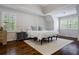 Bright bedroom featuring hardwood floors, natural light, and a cozy rug at 8895 Club River Dr, Roswell, GA 30076