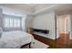 Spacious bedroom featuring hardwood floors, large windows and a modern floating media console at 8895 Club River Dr, Roswell, GA 30076