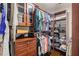 Organized walk-in closet featuring custom shelving, drawers and hanging rods at 8895 Club River Dr, Roswell, GA 30076