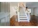 Inviting entryway with hardwood floors and a staircase leading to the upper level at 8895 Club River Dr, Roswell, GA 30076