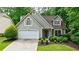 Charming single-Gathering home with a well-manicured lawn and an attached two-car garage at 8895 Club River Dr, Roswell, GA 30076