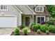 A close-up of the front door, landscaping, and attached garage at 8895 Club River Dr, Roswell, GA 30076