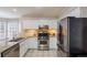 Well-equipped kitchen with stainless steel appliances, granite countertops, and white cabinetry at 8895 Club River Dr, Roswell, GA 30076