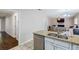 Spacious kitchen with stainless steel appliances, granite countertops, and seamless flow to living spaces at 8895 Club River Dr, Roswell, GA 30076