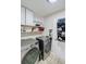 Well-organized laundry room featuring front loading washer and dryer and ample shelving storage space at 8895 Club River Dr, Roswell, GA 30076
