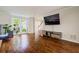 Spacious living room with hardwood floors, natural light, and a stylish entertainment setup at 8895 Club River Dr, Roswell, GA 30076