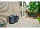View of the outdoor patio with brick pavers and a grill covered with a black tarp at 8895 Club River Dr, Roswell, GA 30076