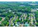 Aerial view of the neighborhood, featuring manicured lawns, mature trees, community pool and tennis courts at 136 Parkstone Way, Marietta, GA 30066