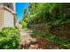 Secluded backyard featuring a retaining wall and mature trees at 136 Parkstone Way, Marietta, GA 30066