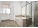 Bathroom showcasing a soaking tub, a glass-enclosed shower, and a vanity at 136 Parkstone Way, Marietta, GA 30066