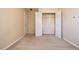 This carpeted bedroom features a standard closet and neutral walls, creating a blank canvas ready for your personal touch at 136 Parkstone Way, Marietta, GA 30066