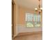 Light-filled dining area featuring wainscoting, a large window, and an elegant chandelier at 136 Parkstone Way, Marietta, GA 30066