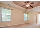 Bedroom with a ceiling fan, tray ceiling, and bright windows overlooking trees at 136 Parkstone Way, Marietta, GA 30066