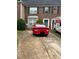 Brick townhome with driveway, green door, and a U-Haul moving truck nearby at 4612 Grand Central Pkwy, Decatur, GA 30035