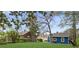 Large, grassy backyard featuring mature trees and two quaint homes, perfect for outdoor activities at 5074 Park Ave, Forest Park, GA 30297