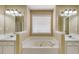 Large bathroom with a tub in between two sinks at 5077 Fieldview Dr, Douglasville, GA 30135