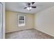 This bedroom features a neutral color palette, carpet, and a ceiling fan at 5077 Fieldview Dr, Douglasville, GA 30135