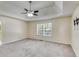 Spacious primary bedroom with a tray ceiling and ceiling fan at 5077 Fieldview Dr, Douglasville, GA 30135