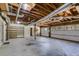 Spacious garage interior with exposed rafters and ample storage space, with a Personal door and garage door at 5077 Fieldview Dr, Douglasville, GA 30135