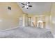 Spacious living room with vaulted ceiling, plush carpet, and staircase; open to other areas of the home at 5077 Fieldview Dr, Douglasville, GA 30135