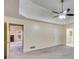 Spacious main bedroom featuring a modern ceiling fan and tray ceiling at 5077 Fieldview Dr, Douglasville, GA 30135