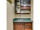 Basement wet bar with wooden cabinets, marble countertop and glass shelving at 5077 Fieldview Dr, Douglasville, GA 30135
