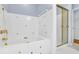 Bathroom featuring a floral tiled shower and tub area with gold fixtures at 740 Skyline Dr, Covington, GA 30014