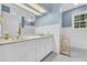 Bathroom with blue striped wallpaper and a double sink vanity at 740 Skyline Dr, Covington, GA 30014