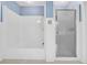 Bathroom with a blue striped wallpaper and a shower and tub combination at 740 Skyline Dr, Covington, GA 30014
