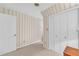 Bedroom with patterned wallpaper, closet, and white door at 740 Skyline Dr, Covington, GA 30014
