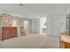 Spacious bedroom with floral wallpaper, hardwood dresser, and window seat offers a comforting retreat at 740 Skyline Dr, Covington, GA 30014
