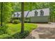 Charming home with a well-manicured lawn and a curved driveway surrounded by mature trees at 740 Skyline Dr, Covington, GA 30014