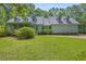 Charming two-story home with dormer windows, a covered porch, and a lush green lawn at 740 Skyline Dr, Covington, GA 30014