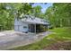 Exterior view of a charming home featuring a screened porch, dormer windows, and a two-car garage at 740 Skyline Dr, Covington, GA 30014