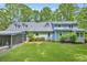 Rear exterior view of a charming home showing the yard and screened porch at 740 Skyline Dr, Covington, GA 30014