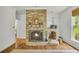 Cozy room featuring a brick fireplace with wood burning, built-in shelves and hardwood floors at 740 Skyline Dr, Covington, GA 30014