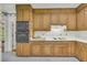 Classic kitchen featuring wooden cabinets, and white countertops, with a stove top at 740 Skyline Dr, Covington, GA 30014