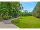 Beautifully maintained lawn with mature trees and a winding driveway, providing ample space and privacy at 740 Skyline Dr, Covington, GA 30014
