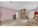 Living room with brick accent wall, pink walls, and carpeted floors at 740 Skyline Dr, Covington, GA 30014