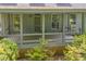 Inviting covered porch with wood railings and ample natural light filtering through multiple windows at 740 Skyline Dr, Covington, GA 30014