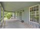 Inviting screened porch with wood floors, and views of the natural landscape at 740 Skyline Dr, Covington, GA 30014