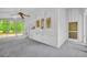 Sunroom offers a ceiling fan, wooded view, and unique decor in a bright and airy space at 740 Skyline Dr, Covington, GA 30014