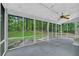 Enclosed sunroom provides wooded views, a ceiling fan, and offers relaxation space at 740 Skyline Dr, Covington, GA 30014
