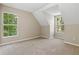 Bedroom featuring plush carpeting, vaulted ceilings, and natural light from the windows at 1333 Laura Ln, Austell, GA 30168