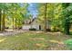 Charming two-story home with attached garage, a well-manicured lawn, and mature trees at 1333 Laura Ln, Austell, GA 30168