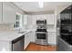 Modern kitchen with quartz countertops, stainless steel appliances, and white cabinets at 1333 Laura Ln, Austell, GA 30168